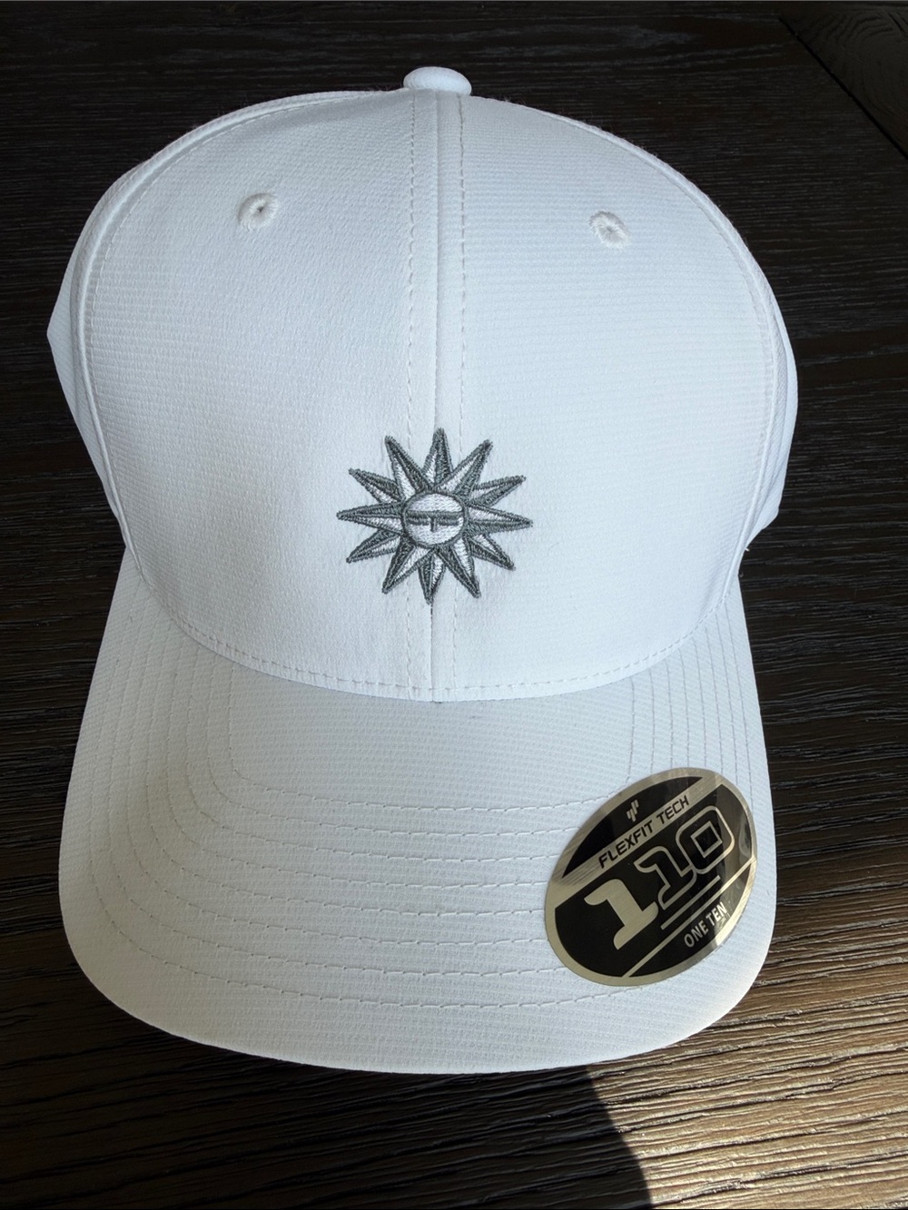 Tuscany Gold Course White Flexfit Tech Cap with Embroidered Sunburst Emblem